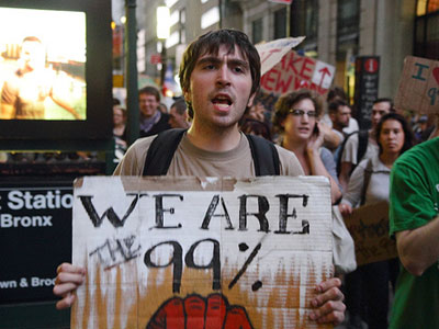 man-with-99-sign-marching-for-occupy-wall-street-in-nyc.jpg